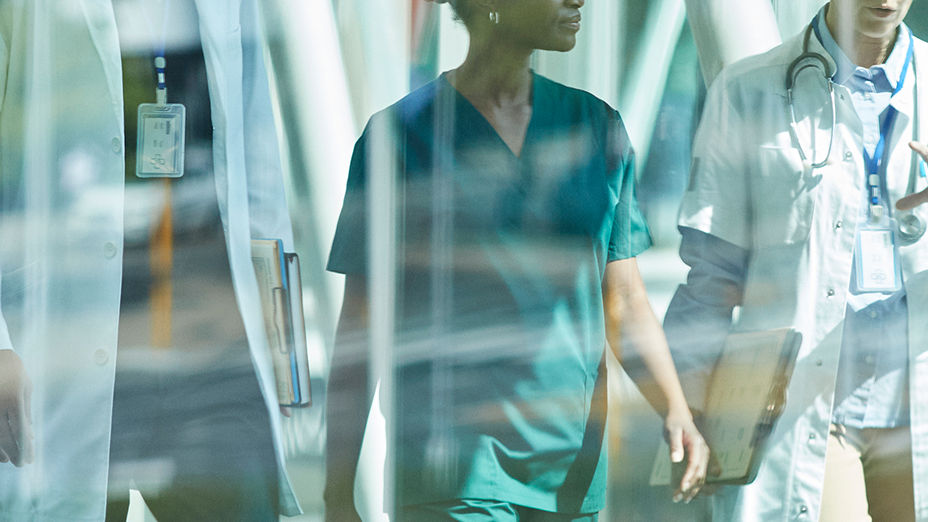 Two doctors and a nurse walking